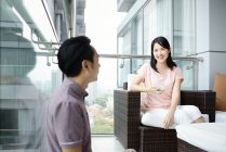 Mature asian casual couple sitting at home — Stock Photo