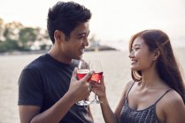 Attractive young asian couple having drink — Stock Photo