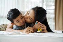 Mother bonding with her son on the bed — Stock Photo