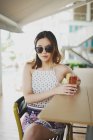 Portrait of young attractive asian woman having drink — Stock Photo