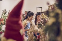 Two young asian woman shopping together in mall at christmas — Stock Photo