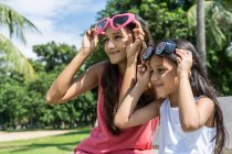 Portrait of mother and daughter wearing funny glasses — Stock Photo
