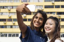 Young casual asian girls taking selfie — Stock Photo