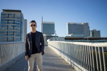 Portrait of stylish young asian man on street — Stock Photo