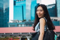 Portrait of young asian woman in city — Stock Photo