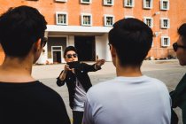 Cool young asian rock band taking photo — Stock Photo