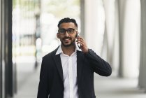 Young successful businessman using smartphone — Stock Photo