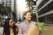 Young chinese couple at grocery shopping — Stock Photo