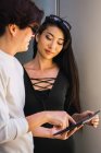 Young asian couple sharing tablet together — Stock Photo