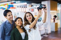 Young asian business people taking selfie by camera — Stock Photo