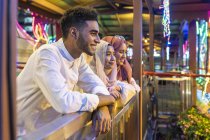 A group of friends enjoying the view of geylang bazaar. — Stock Photo