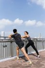 Asian couple during  fitness leaning on railing — Stock Photo