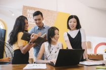 Young asian people in creative modern office — Stock Photo
