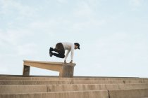 Young Asian man doing parkour on stairs — Stock Photo