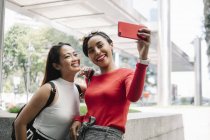 Young asian female friends taking selfie — Stock Photo