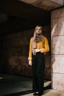 Jeune asiatique musulman femme dans hijab posant à bâtiment — Photo de stock