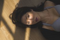 Портрет молодой азиатки, лежащей на полу — стоковое фото