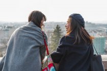 Young adult asian female friends in park, rear view — Stock Photo