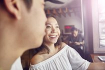 Happy young asian couple together in bar — Stock Photo