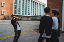 Cool young asian rock band taking photo — Stock Photo