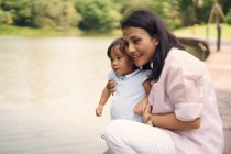 Cute asian mother and daughter together in park — Stock Photo