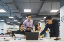 Young asian business people at work in modern office — Stock Photo