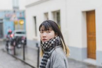 Young attractive casual asian woman on city street — Stock Photo