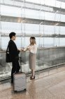 Young asian couple of businesspeople in airport — Stock Photo
