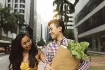 Young chinese couple at grocery shopping — Stock Photo