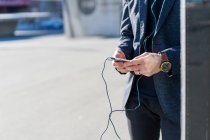 Cropped image of young asian man using smartphone — Stock Photo