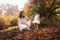 Cute asian mother and daughter having fun in park — Stock Photo
