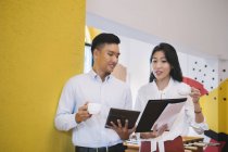 Young asian people working in creative modern office — Stock Photo