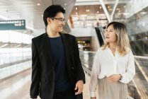 Jeune couple asiatique d'hommes d'affaires marchant dans l'aéroport — Photo de stock