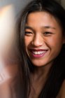 Retrato de joven atractivo asiático mujer sonriendo a cámara - foto de stock
