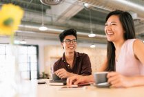 Young asian successful business people in modern office — Stock Photo