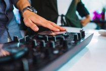 Cropped image of man using dj device in modern office — Stock Photo