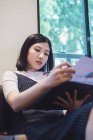 Young asian woman working in creative modern office — Stock Photo