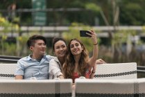 Group of friends at a restaurant taking selfie — Stock Photo