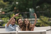 Group of friends at a restaurant, taking selfie — Stock Photo