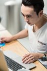 Young man using laptop in a startup environment. — Stock Photo