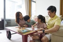 Family bonding at home over a colouring activity for the children — Stock Photo