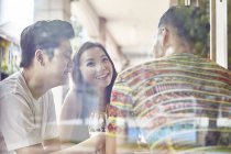 Happy young asian friends together in bar — Stock Photo