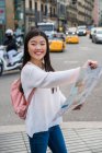 Young Chinese woman with a map in Barcelona — Stock Photo
