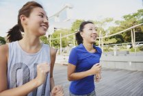 Jeunes femmes asiatiques courir à l'extérieur — Photo de stock