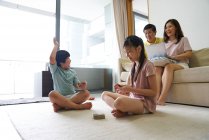 RELEASES Happy young asian family together spending time at home — Stock Photo