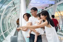 RELEASES Happy asian family spending time together and pointing — Stock Photo