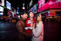 Happy family having a good time on Times Square in New York — Stock Photo