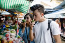 RELEASES Young asian couple sightseeing in a local market in Ho Chi Minh City, Vietnam. — Stock Photo