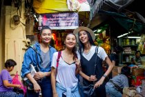 Друзья весело покупают уличную еду в Чайнатауне, Таиланд — стоковое фото