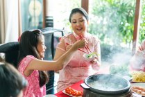 Happy asian family together eating at home — Stock Photo